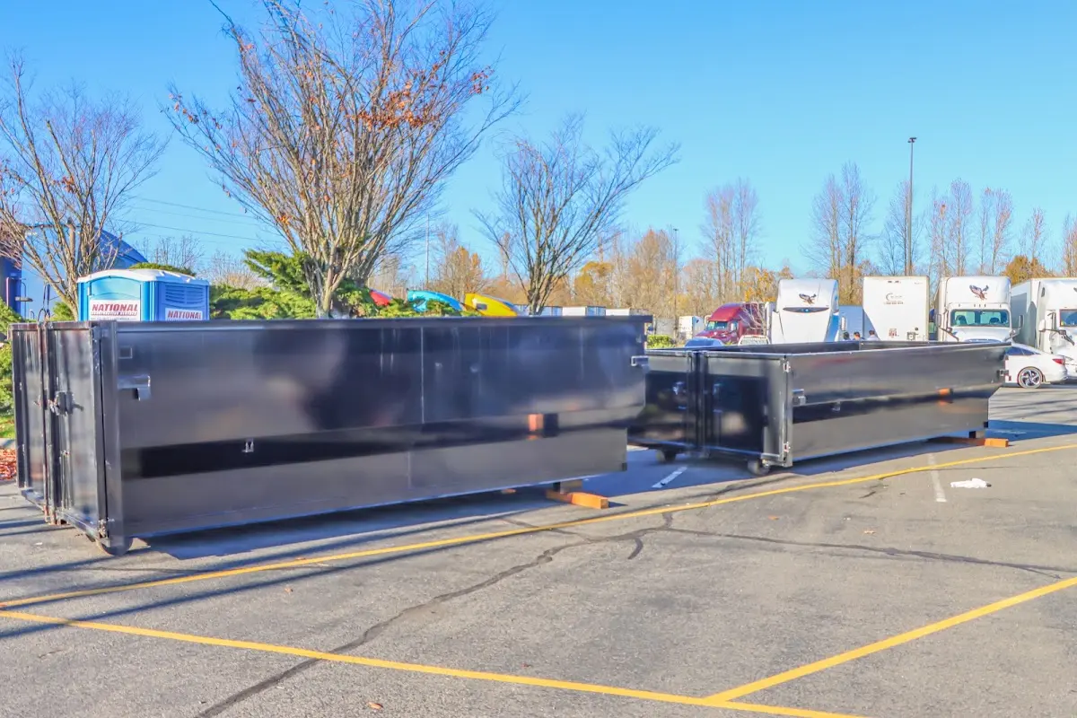 Professional dumpster rental service with roll-off container on residential driveway in Trinidad